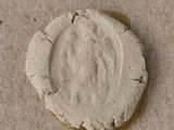a cookie that is sitting on the ground next to some dirt