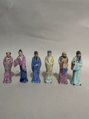 five figurines of people standing in a row