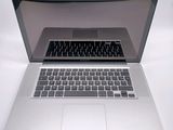 a silver laptop computer sitting on top of a white table