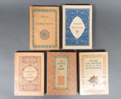 four books are lined up in a row on a gray surface