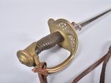 a close up of a sword on a white surface