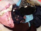 a pile of clothes that is on a bed