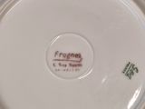 a close up of a plate with a frog on it