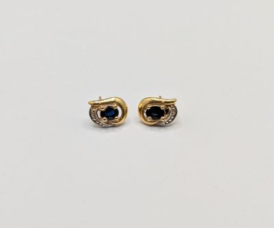 a pair of gold and sapphire earrings
