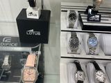 a lot of watches on display in a glass case