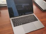 a laptop computer sitting on a wooden table