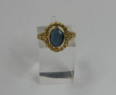 a close up of a ring with a blue stone in it
