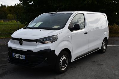 la photo d'une camionnette blanche garée sur un parking