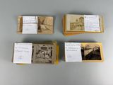 several old photos of people sitting on top of a table next to a pile of papers