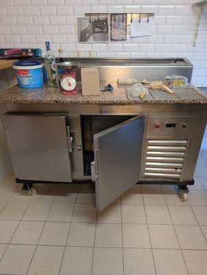 a stainless steel kitchen with a sink and a counter