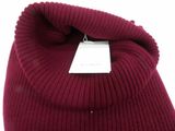 a close up of a red sweater with a tag on it