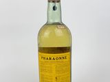 a close up of a bottle of alcohol on a white surface