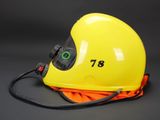 a close up of a yellow helmet with a cord attached to it