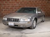 a silver car that is parked in a parking lot