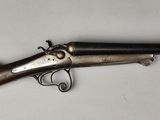 a rifle with a wooden barrel and a wooden handle
