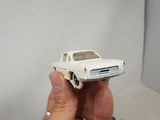 a person holding a toy car in their hand