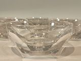 three clear glass bowls sitting on top of a white table