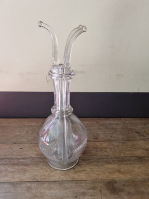 a clear glass vase sitting on a wooden table