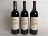 three bottles of wine sitting on top of a table next to each other