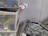 two plastic bins with legos in them on the floor