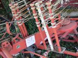 a red machine that is sitting in the grass