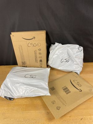 three bags of white plastic sitting on top of a wooden table