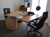 a desk with a chair and a computer on it