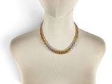 a close up of a mannequin wearing a necklace on a mannequin head