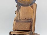 an egg sitting on top of a stack of books next to a pair of scissors