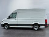 the white van is parked in a parking lot near a building