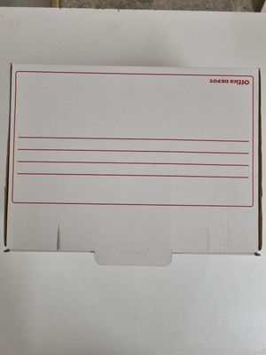 a white box with a red line on it sitting on top of a table
