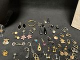 many different types of earrings on the table