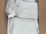 a cardboard box filled with a lot of white towels