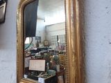 a mirror hanging on the wall next to a sink