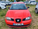 a red car that is parked in the grass