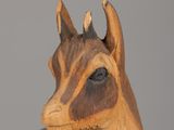 a wooden sculpture of a deer with horns on it ' s head