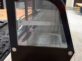 a glass display case that is on top of a table