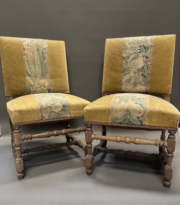 two chairs with a yellow upholstered upholstered back and a green upholstered back