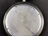 an old silver pocket watch with a chain hanging from it ' s side