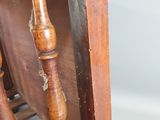 a close up of a wooden chair with a wooden spindle