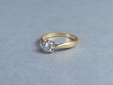 a close up of a gold ring with a diamond on it