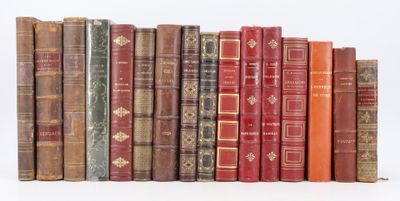 many old books lined up together on a white surface