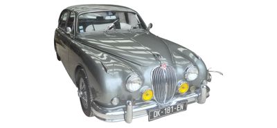 a silver car that is sitting on a white surface
