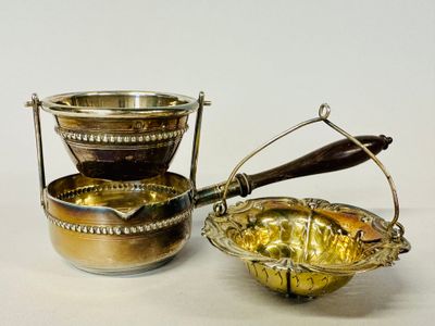 a silver bowl with a spoon in it next to a silver bowl with a spoon in it