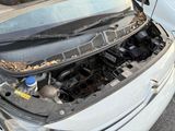 a car that has its hood open on the street