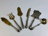 five different types of kitchen utensils on a white surface