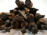 a pile of bananas sitting on a table with a knife