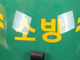 a close up of a green helmet with yellow writing on it