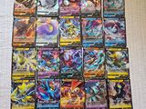 a pile of pokemon cards sitting on top of a table