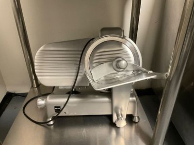 an image of a meat slicer sitting on a table